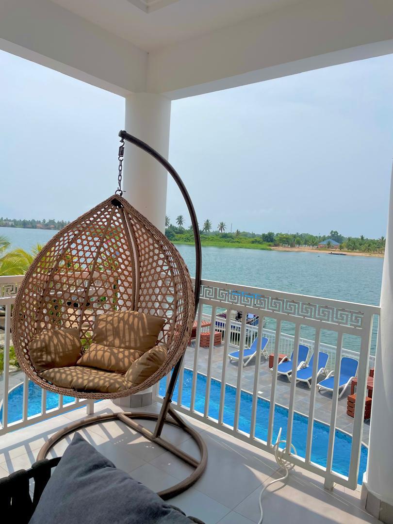 Balcony hanging chair overlooking the pool and the Volta estuary