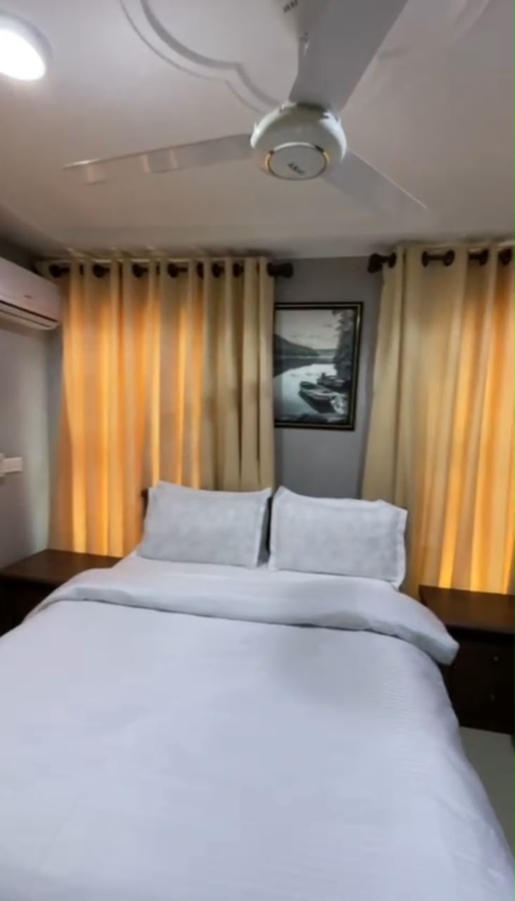 Standard Room with queen bed and warm curtains